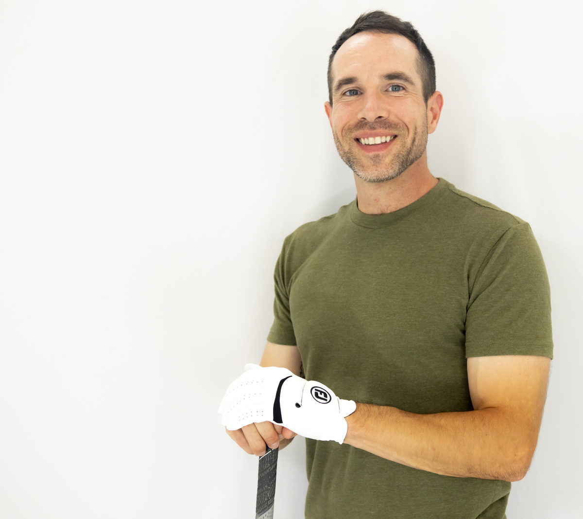 Matt Citron of Namaste Golf, holding a club with a gloved hand.